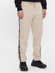 Calvin Klein Jeans Spodnie dresowe Logo Tape J30J324376 Beżowy Relaxed Fit
