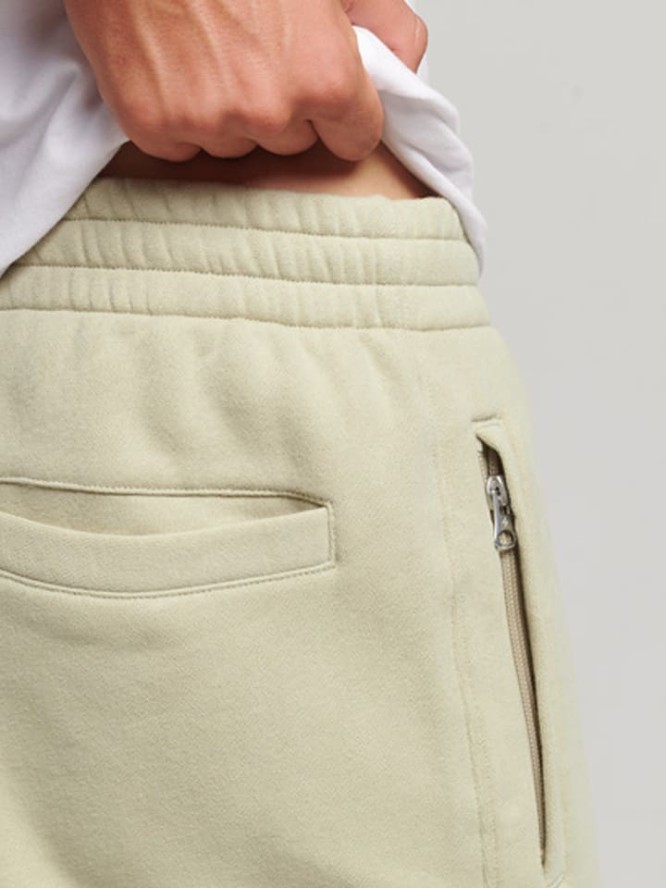 Superdry Spodnie dresowe w kolorze beżowym rozmiar: M