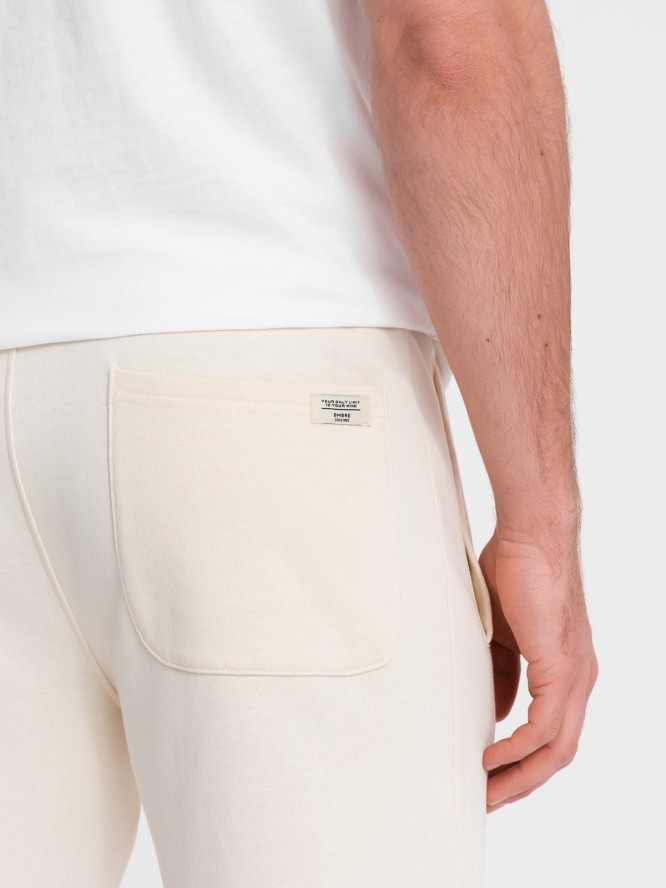 Męskie spodnie dresowe z nogawką bez ściągacza - kremowe V11 OM-PABS-0206 - XXL