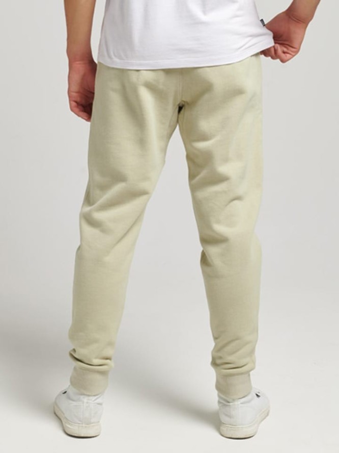 Superdry Spodnie dresowe w kolorze beżowym rozmiar: M